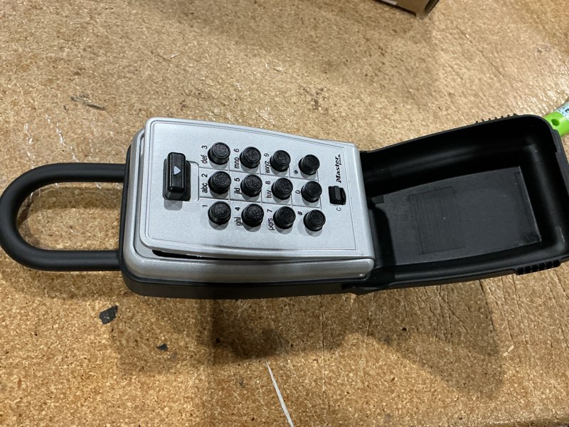 Condition photo showing Good Condition for master lock black outdoor key lock box with push buttons to hide a key, easily set, share, and change combination for tenants, guests, clients, move between listings, 5422e 3-1/2 in. h. x 2-1/4 in. w. x 1 in. d. 1 pack