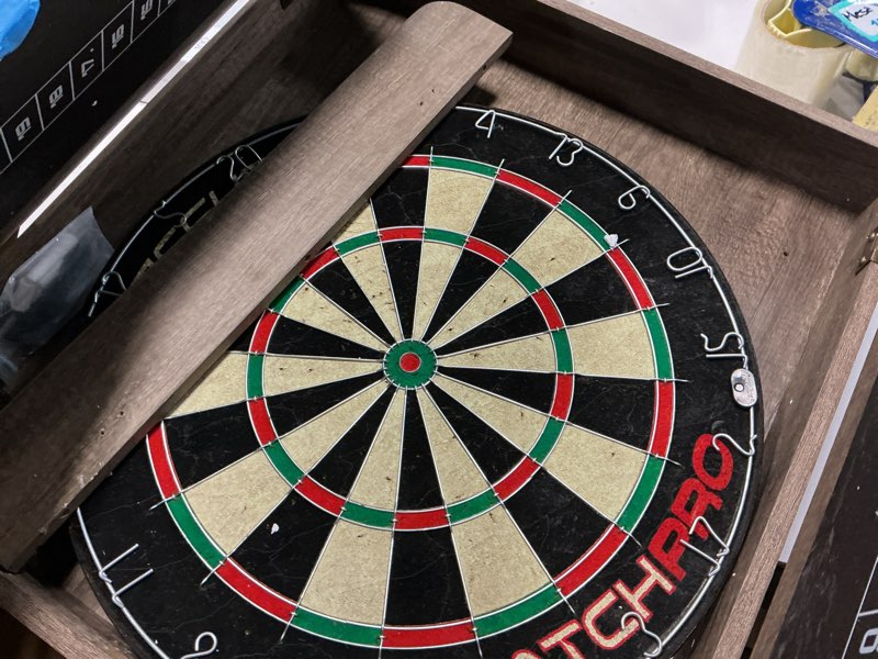 Condition photo showing As Is for Accudart Match Pro Dartboard Cabinet Set - Official Size - Self Healing Sisal - Modern Style Woodgrain - Two Built-in Dartholders - LED Lighting - Includes Scoreboard, Chalk, Eraser, and Six Darts