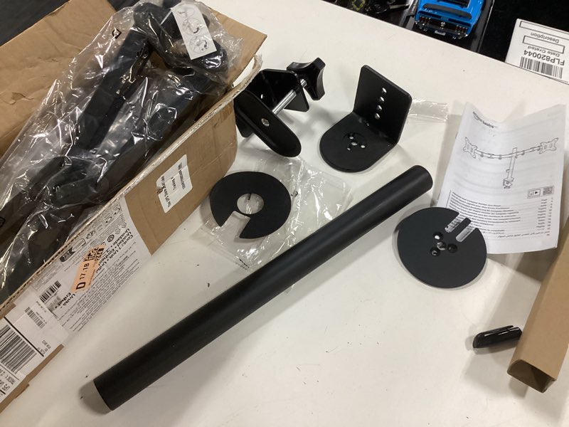 Condition photo showing As Is for amazon basics adjustable dual monitor desk mount, holds up to 32" monitors, black dual adjustablemonitorarm