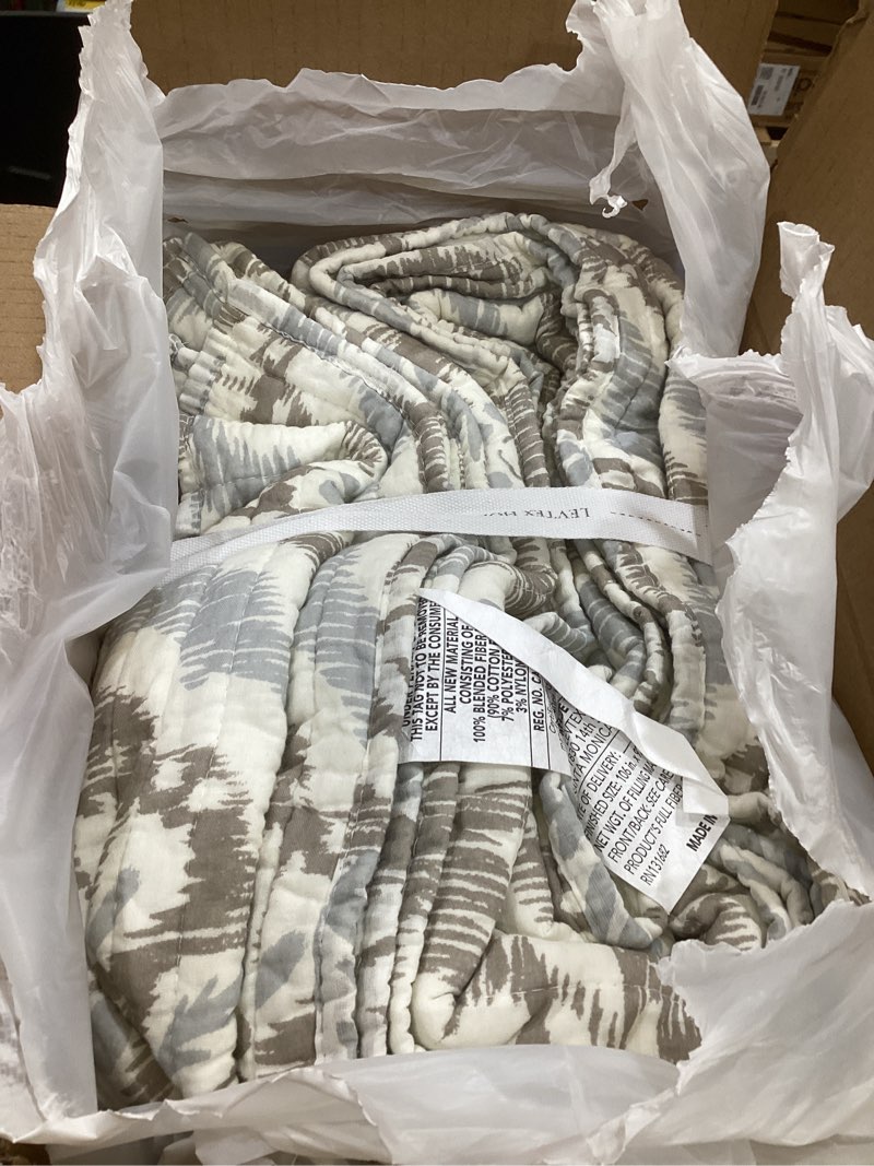 Condition photo showing As Is for levtex home - becker taupe quilt set - king quilt and two king shams - ikat - taupe, grey and cream - quilt (106x92in.) and shams (20x36in.) - reversible - cotton quilt - king/cal king taupe