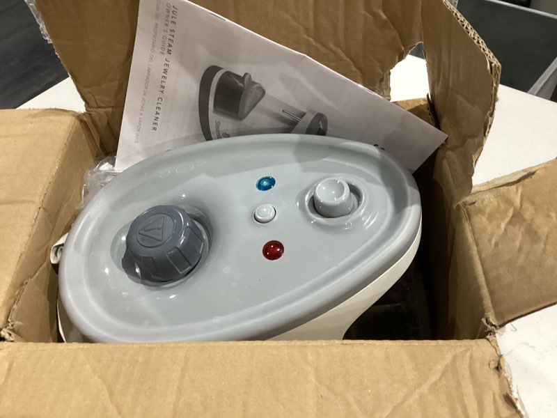 Condition photo showing As Is for steamfast sf-1000 jule steam jewelry cleaner, led lighting, chemical free, 15 minute run-time, included cleaning accessories, 12-ounce water tank, quick heat-up time, white tabletop