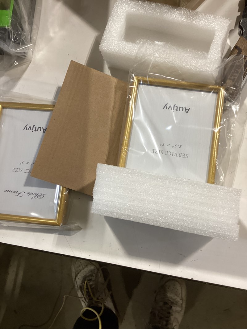 Condition photo showing Good Condition for 3.5x5 picture frame matte gold modern simple thin aluminum metal photo frame with hd real glass, display for tabletop and wall collage. (2 pack) 3.5x5 gold