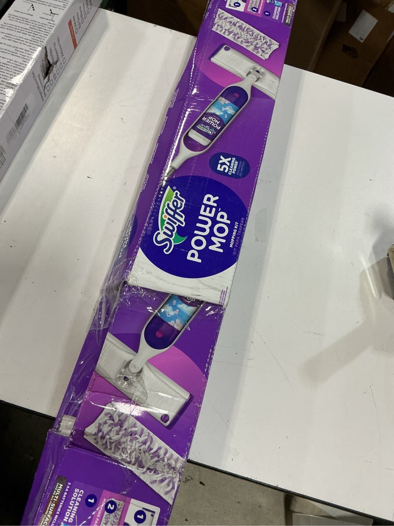 Condition photo showing As Is for swiffer powermop multi-surface mop kit for floor cleaning, includes powermop, 2 mopping pad refills, 1 cleaning solution with fresh scent and 2 batteries purple and white