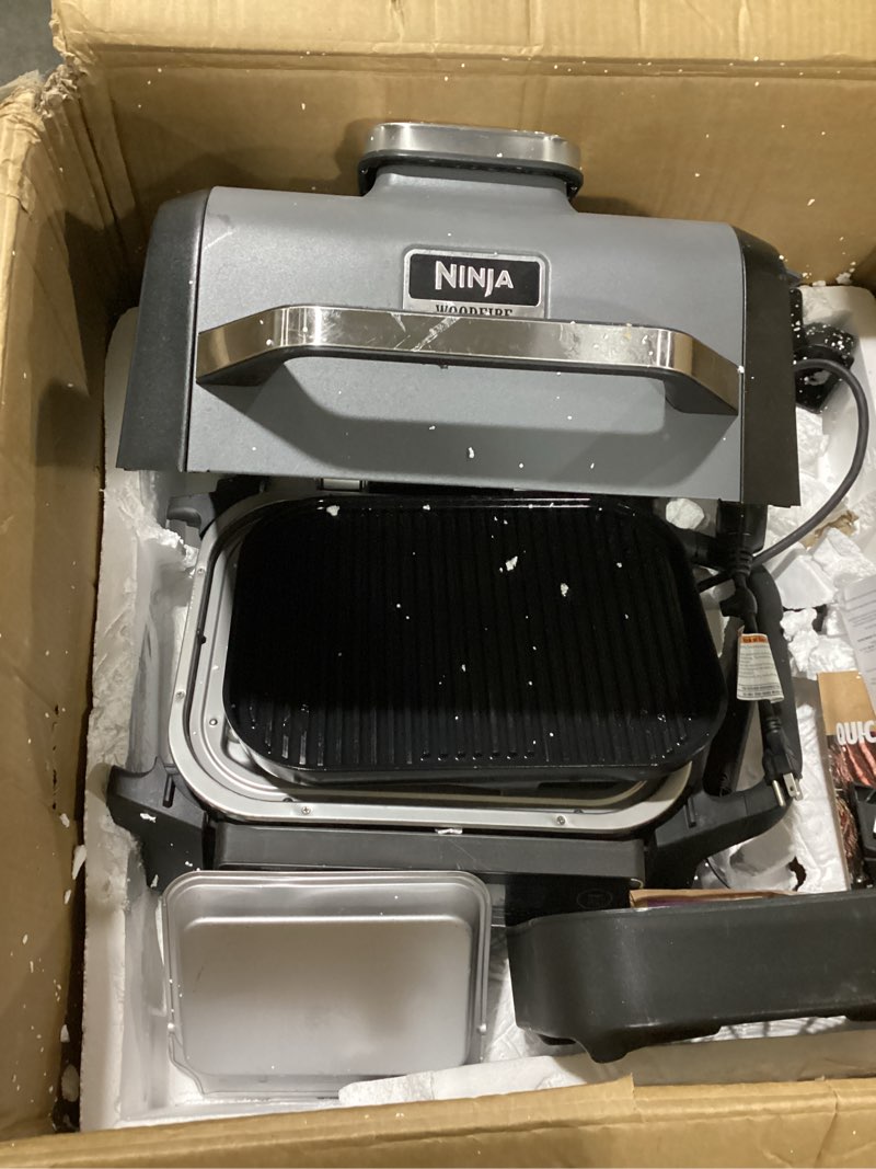Condition photo showing As Is for ninja og751 woodfire pro outdoor grill built-in thermometer,7-in-1 master grill,bbq smoker,& outdoor air fryer plus bake,roast,dehydrate & broil,woodfire technology,weather-resistant,grey xl 7-in-1 grill+thermometer
