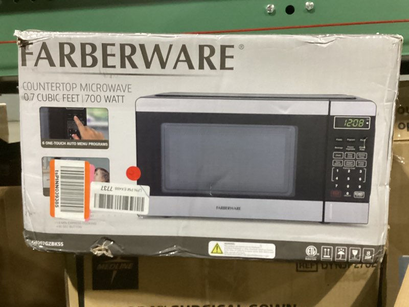 Condition photo showing As Is for Farberware 0.7 Cu. Ft. Countertop Microwave Oven – 700 Watts Power, Auto Cook Settings, Defrost, Easy Clean and Child Safety Lock - Stainless and Black
