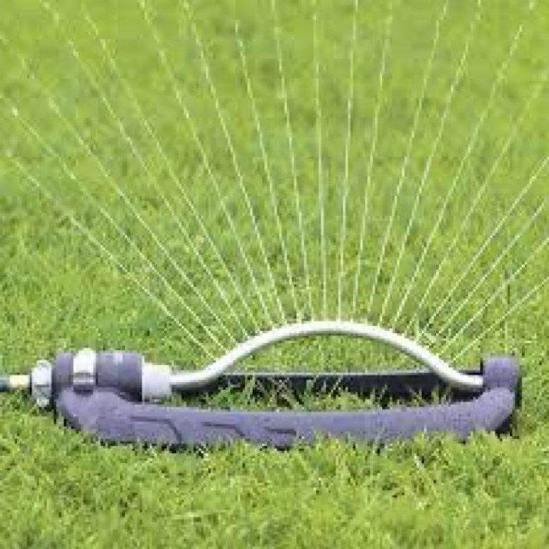 project source 4000-sq ft oscillating sled lawn sprinkler features a black and silver design with brass nozzles for durable watering.