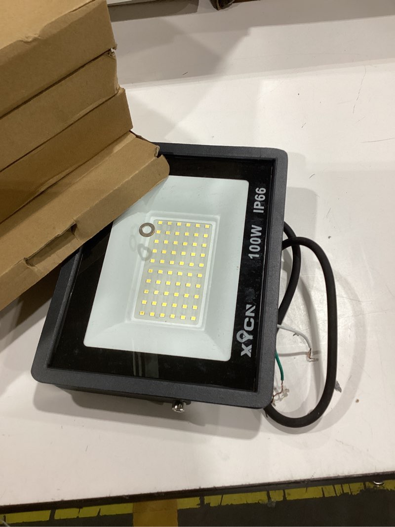 Condition photo showing As Is for xycn 4 pack 100w led flood light, ip66 waterproof outside flood light, 12500lm super bright outdoor security lights, 5000k daylight white floodlight for yard garden playground basketball court patio 100w led flood light 4pack