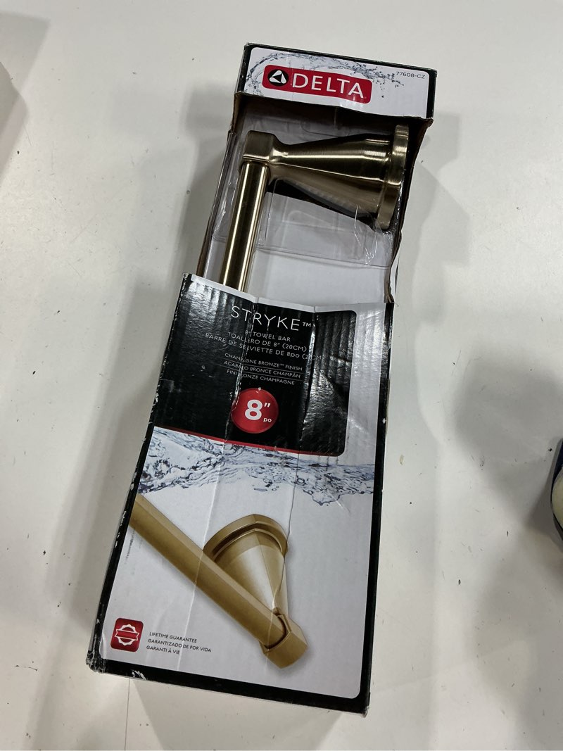 Condition photo showing New/Like New for delta stryke 8-in champagne bronze wall-mount single towel bar