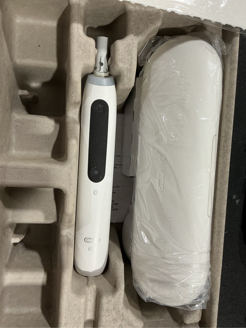Condition photo showing As Is for oral-b io series 5 electric toothbrush with (1) ultimate white brush head, rechargeable, white