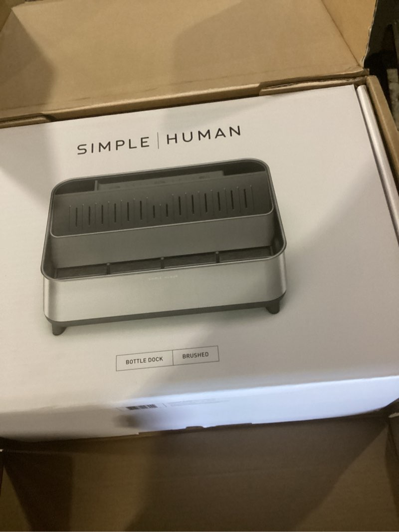 Condition photo showing New/Like New for simplehuman bottle dock, steel frame fast drying bottle rack, three-compartment organizer for tumblers, caps & straws, brushed stainless steel