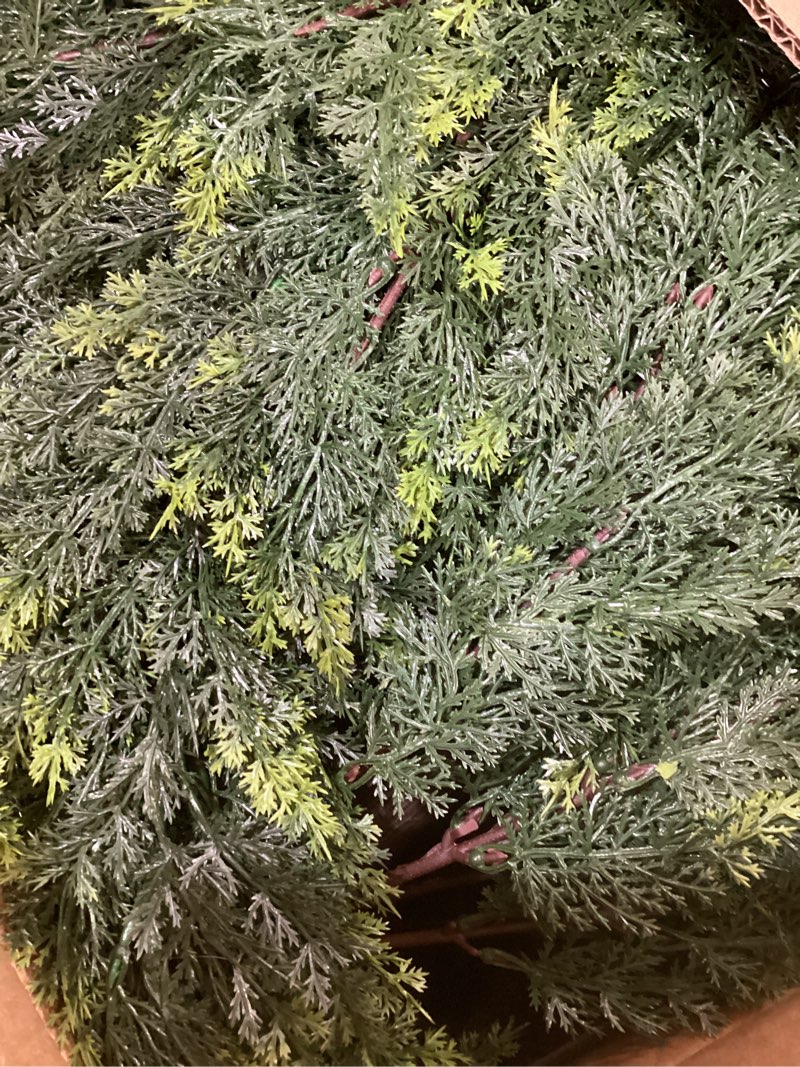 Condition photo showing Good Condition for this product is a set of faux cedar branches or a garland, designed to mimic the appearance and texture of real evergreen foliage for decorative purposes. 