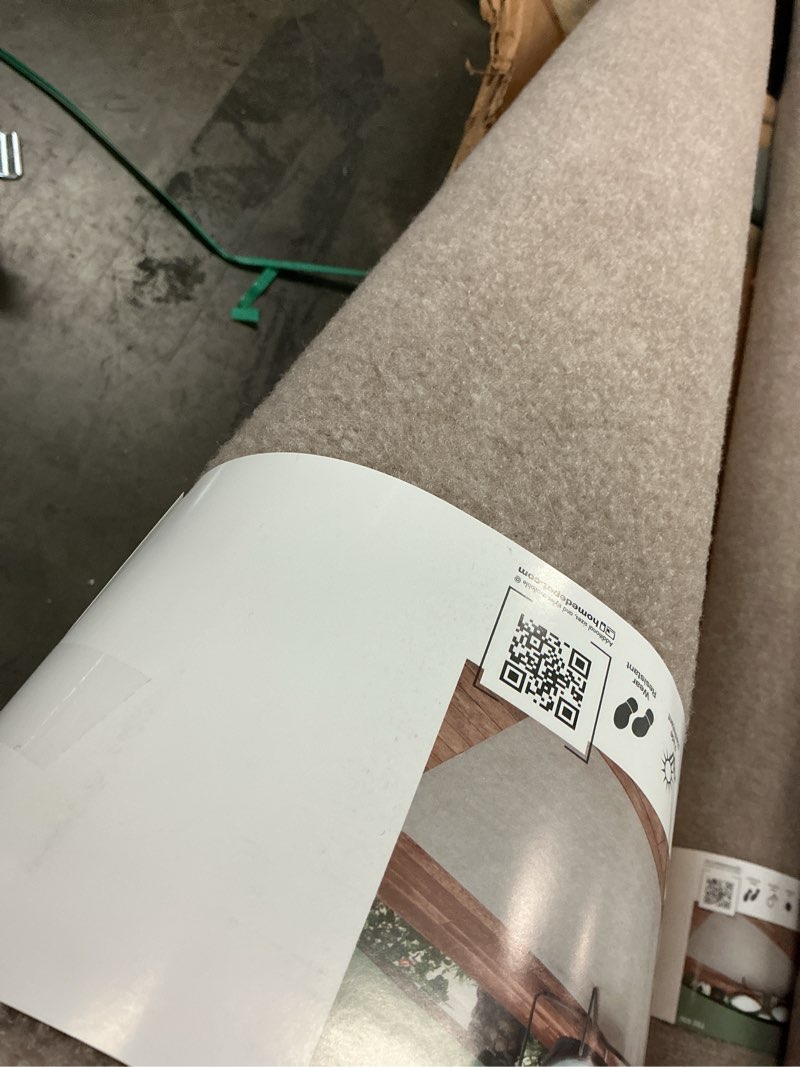 Condition photo showing Good Condition for trafficmaster ribbed taupe 6 ft. x 8 ft. indoor/outdoor area rug