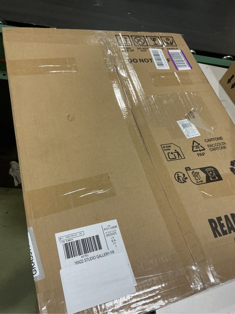 Condition photo showing Good Condition for mcs studio gallery 16x22 matted poster frame with 12x18 picture display, black woodgrain engineered wood vertical & horizontal wall hanging large picture frame for photos, posters & art prints (1-pack) 1-pack black woodgrain 12x18