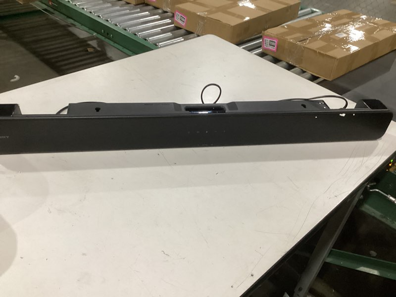 Condition photo showing New/Like New for Sony S100F 2.0ch Soundbar with Bass Reflex Speaker, Integrated Tweeter and Bluetooth, (HTS100F), easy setup, compact, home office use with clear sound black