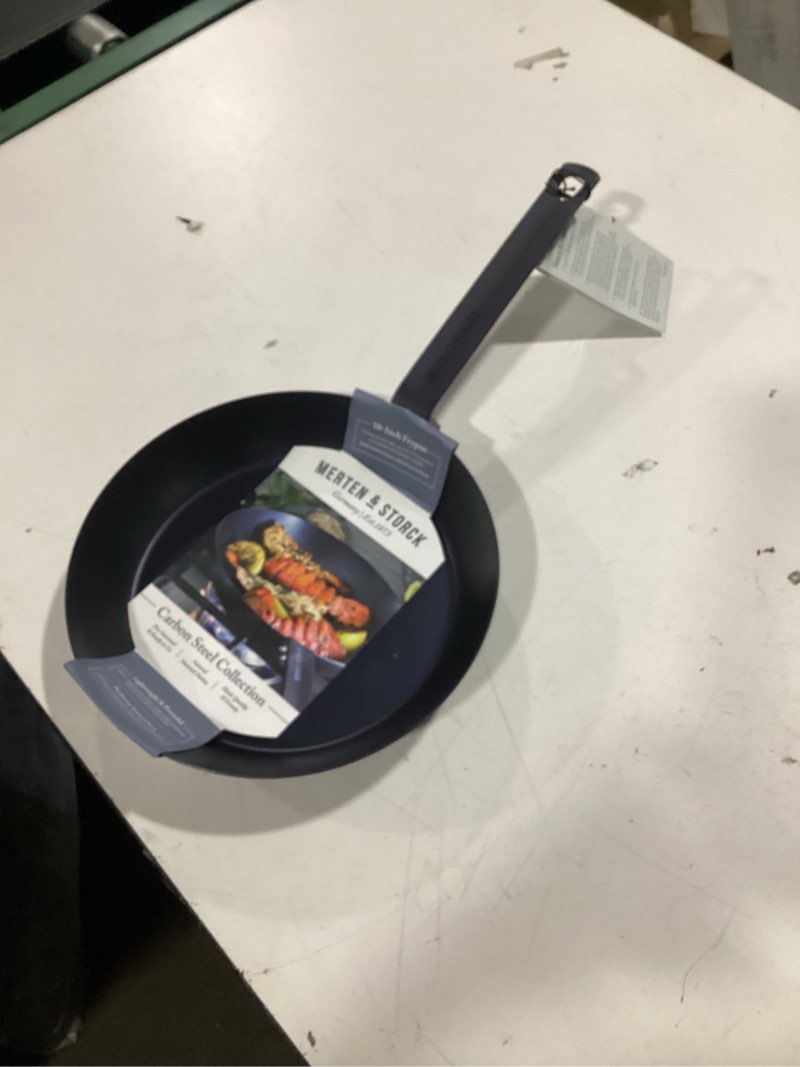 Condition photo showing New/Like New for merten & storck pre-seasoned carbon steel 10” frying pan skillet, use on induction, stove and grill, durable, even-heating, for searing, grilling, oven use, and campfire, indoor/outdoor 10" frying pan skillet black