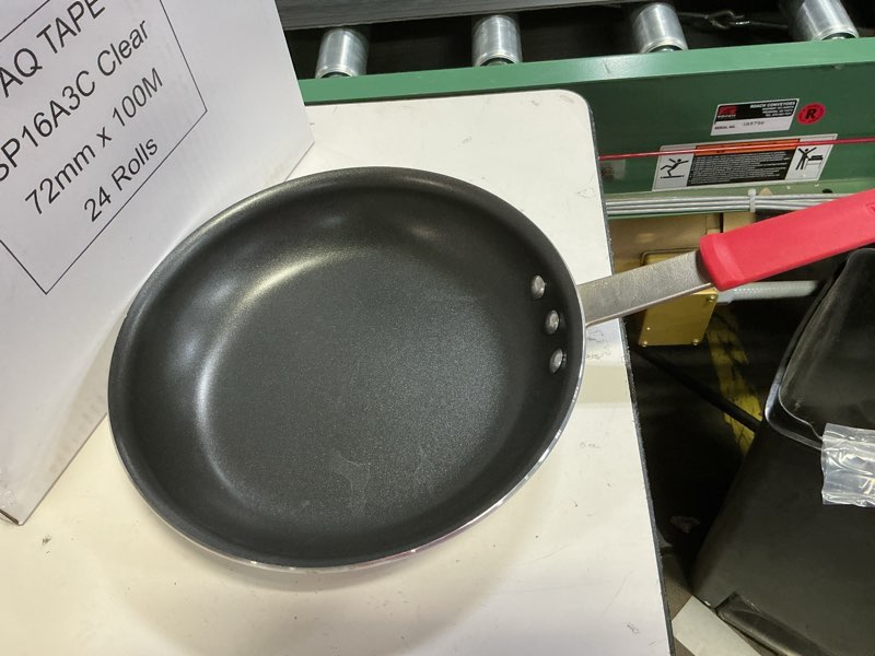 Condition photo showing As Is for Tramontina Professional 12-Inch Non Stick Large Frying Pan, Heavy-Gauge Aluminum Skillet with Reinforced Nonstick Coating, Red Handle, Dishwasher and Oven Safe