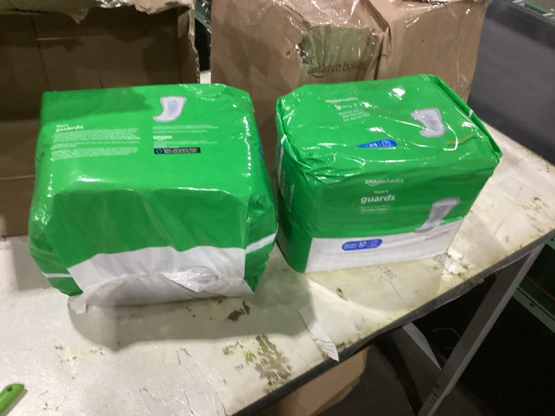 Condition photo showing New/Like New for Amazon Basics Men's Incontinence Guards, Maximum Absorbency, 104 Count, (2 Packs of 52)