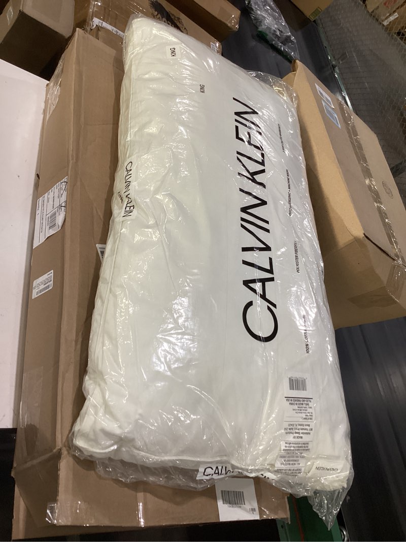 Condition photo showing New/Like New for Calvin Klein Down Around Firm Support Pillow, Dual Core Down Feather Design, Ideal for Stomach and Back Sleepers, Measures 20" x 36", King Size