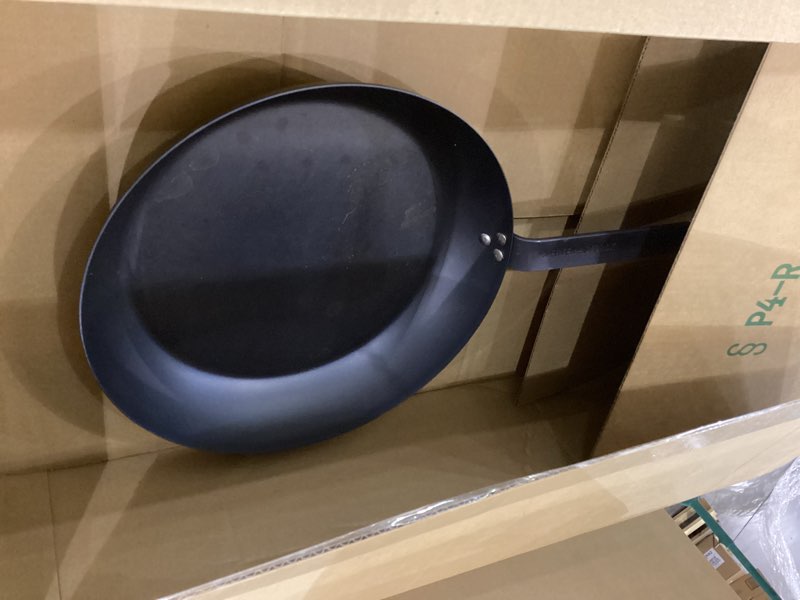 Condition photo showing As Is for merten & storck pre-seasoned carbon steel 12” frying pan skillet, use on induction, stove and grill, durable, even-heating, for searing, grilling, oven use, and campfire, indoor/outdoor 12" frying pan skillet black