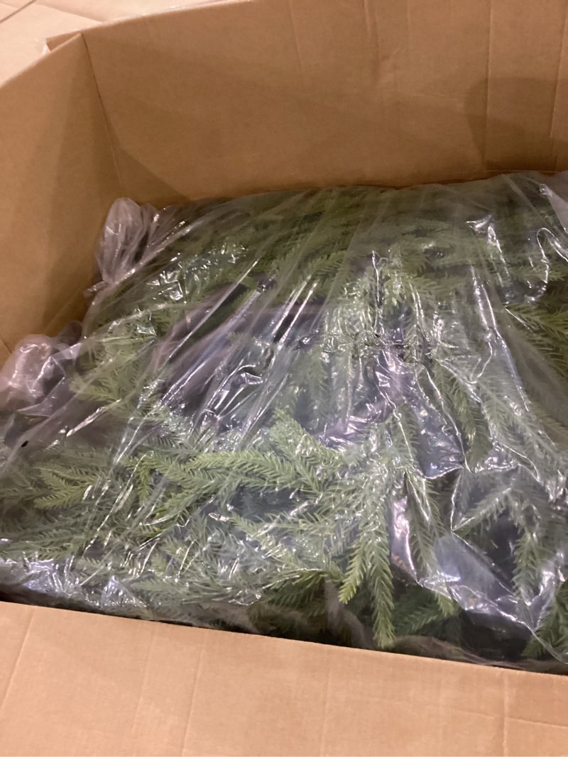 The image shows artificial Norfolk Pine Christmas garlands. 