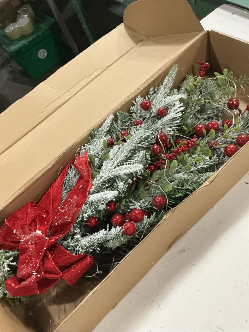 Condition photo showing New/Like New for 28 inch pre-lit christmas teardrop swag, decorated with artificial flocked pine branch red berry wired bowknot white led light, white snowy christmas decoration for front door outdoor