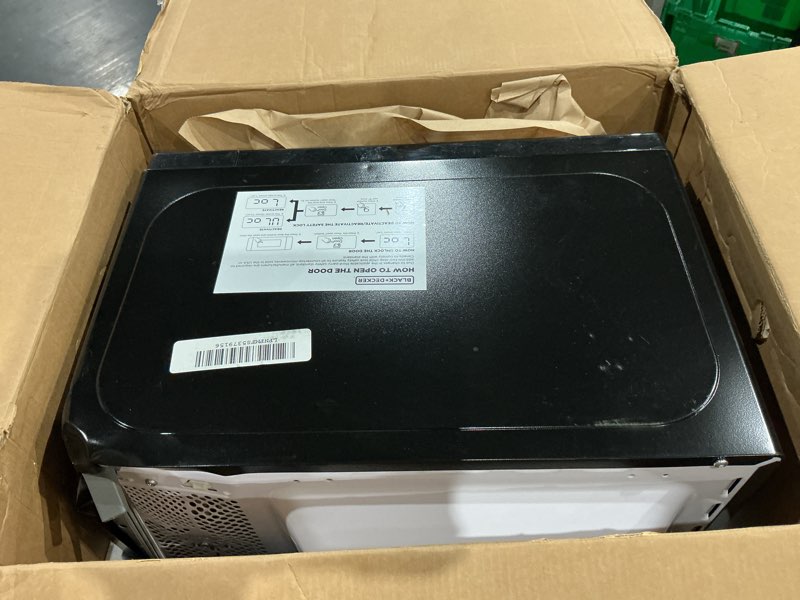 Condition photo showing As Is for black+decker em720cb7 digital microwave oven with turntable push-button door, child safety lock, 700w, stainless steel, 0.7 cu.ft 0.7 cu. ft.