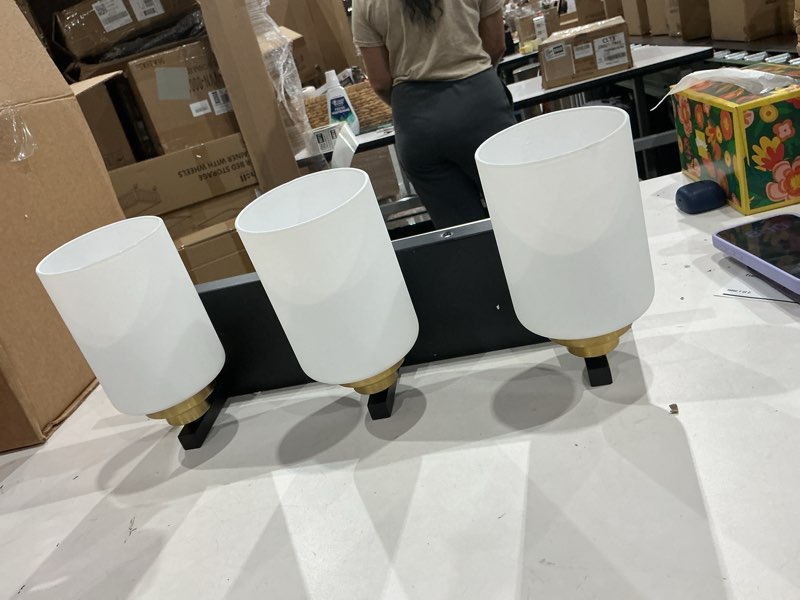 Condition photo showing As Is for light black and gold vanity light with milky white glass shades, wall sconce for bathroom