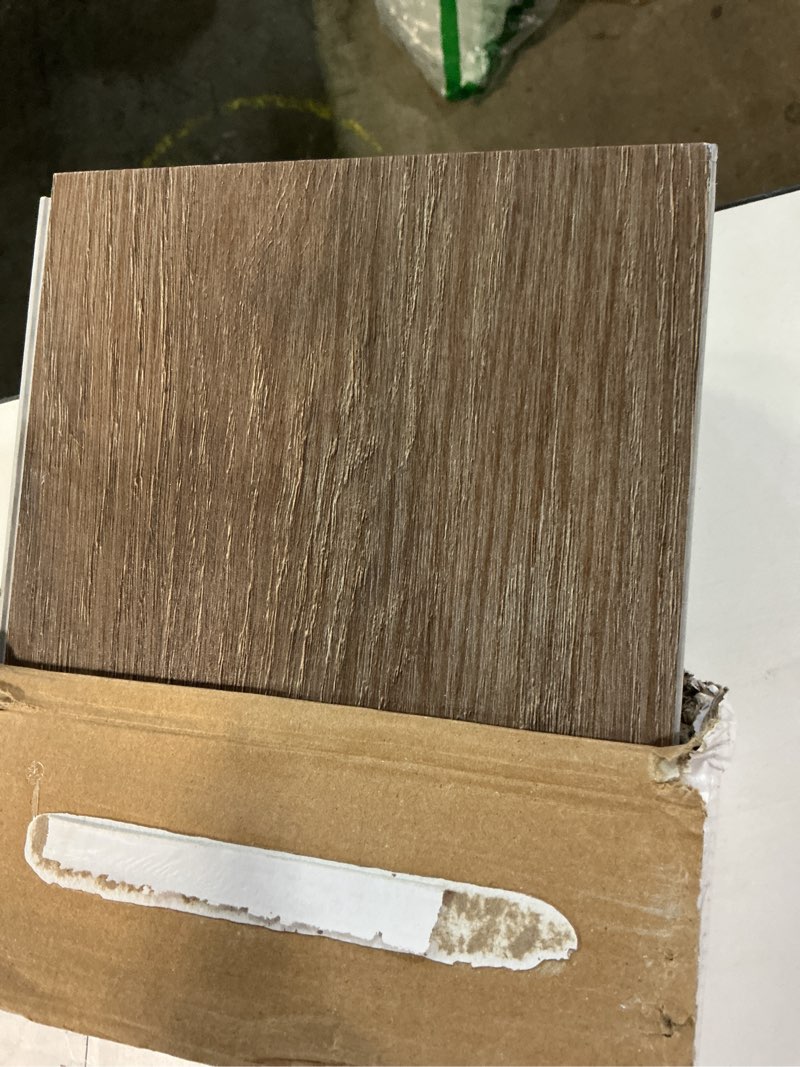 Condition photo showing As Is for style selections penny oak brown 6-mil x 6-in w x 48-in l waterproof interlocking luxury vinyl plank flooring (23.278-sq ft/ carton)