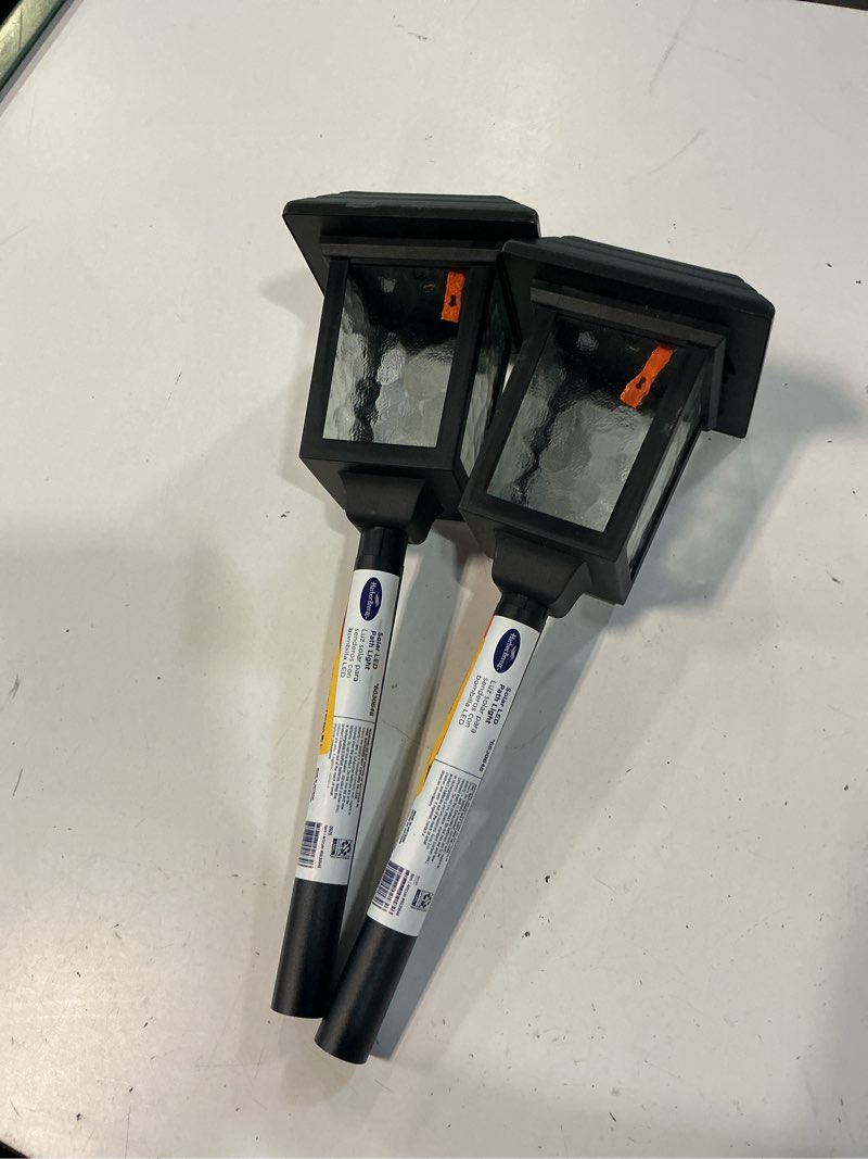 Condition photo showing As Is for harbor breeze 15lm solar path light 15 -lumens black solar led outdoor path light ( 3000-k ) 2pcs
