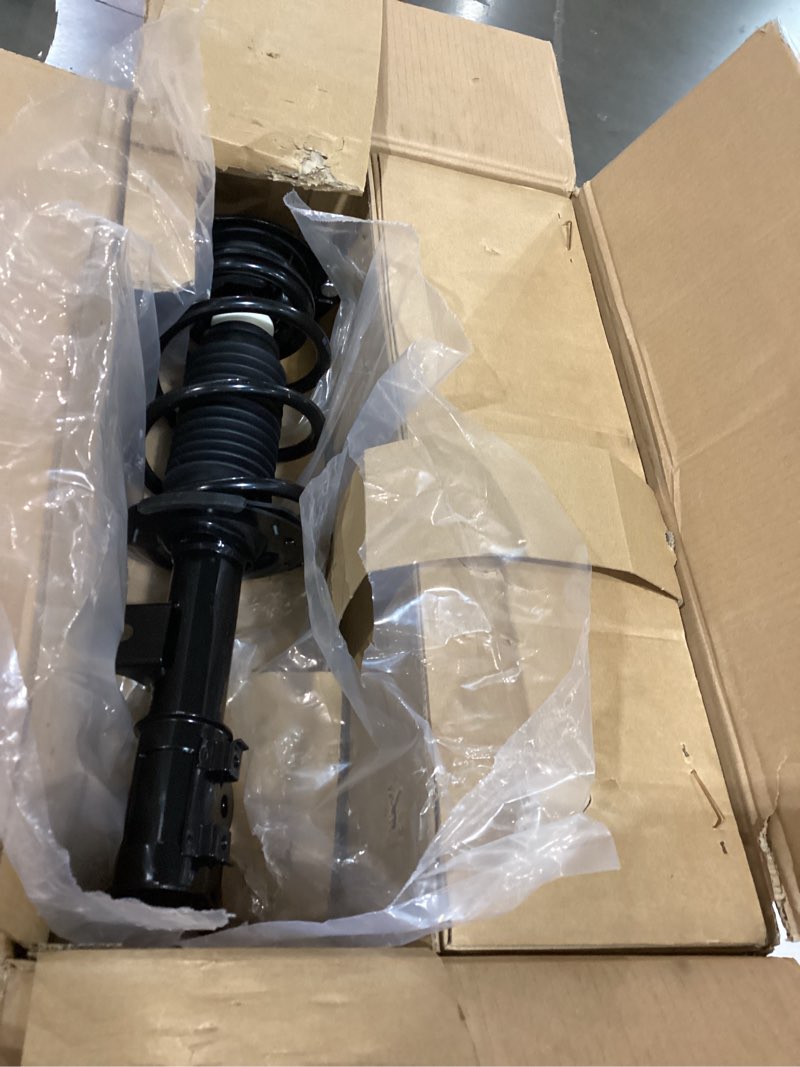 Condition photo showing As Is for front struts w/ coil spring assembly