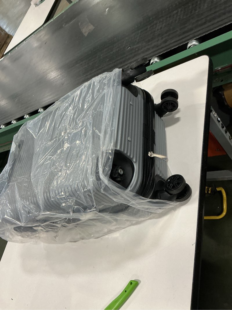 Condition photo showing As Is for Rockland London Hardside Spinner Wheel Luggage, Silver, Carry-On 20-Inch Silver Carry-On 20-Inch