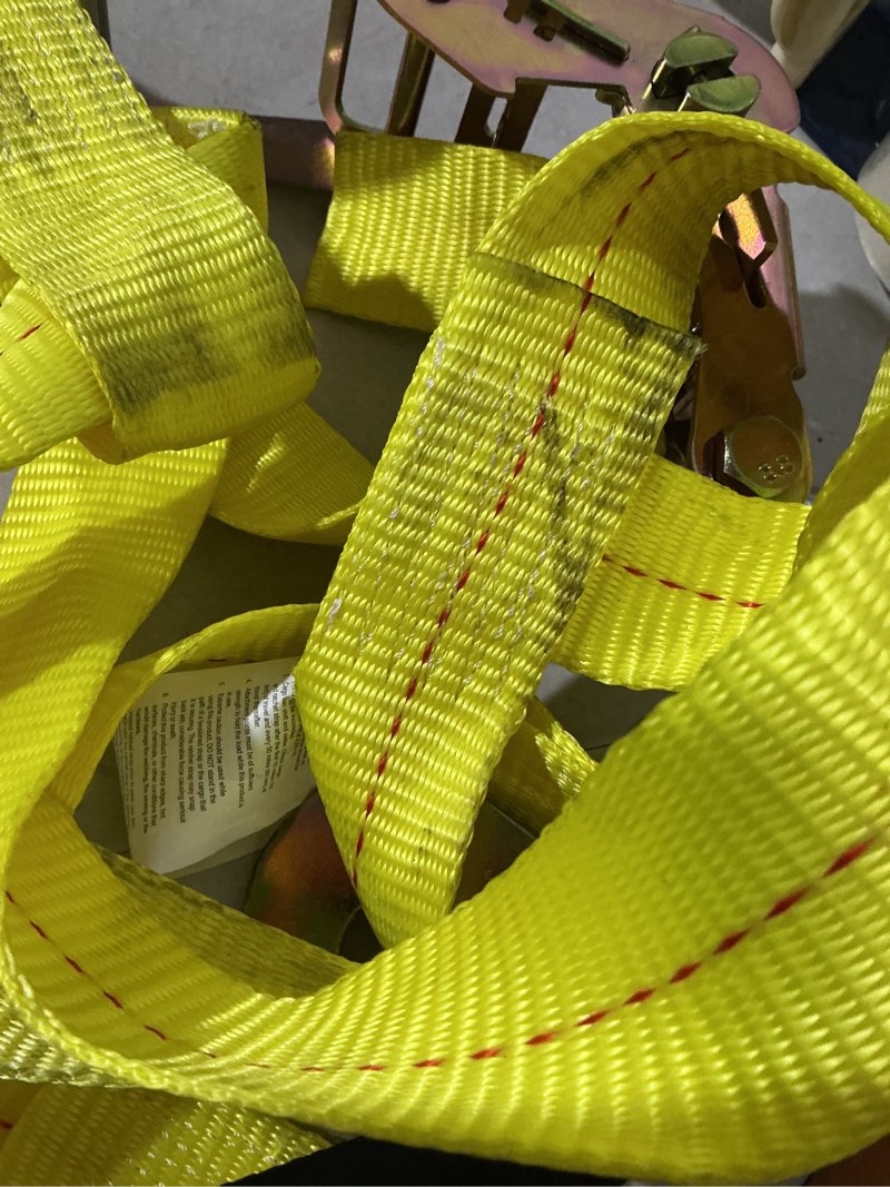 Condition photo showing As Is for tire bonnet ratchet tie down strap with 3,333 lb. safe work load - 1 pack