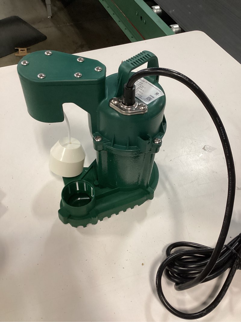 Condition photo showing As Is for zoeller 1/3 hp cast iron submersible sump pump, featuring a green powder-coated housing and a tethered float switch [6.1, 6.3].