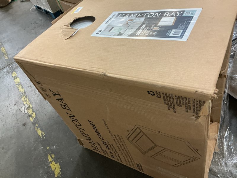 Condition photo showing As Is for courtland 36 in. w x 24 in. d x 34.5 in. h assembled shaker base kitchen cabinet in polar white