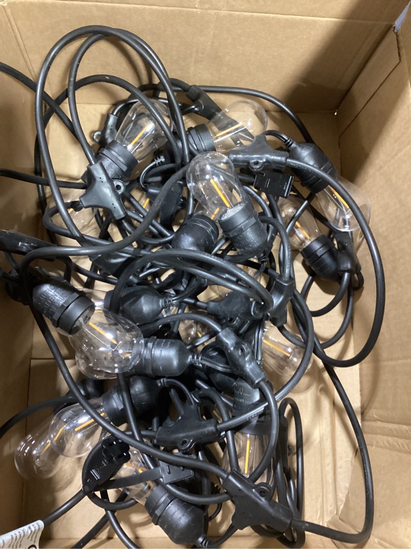 Condition photo showing Good Condition for 12 light 24 ft. indoor/outdoor plug-in no bulbs included edison string light in black