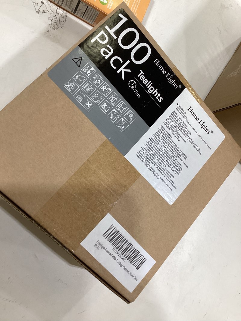 Condition photo showing New/Like New for HomeLights Unscented White Tealight Candles -100 Pack, 6 to 7 Hour Burn Time Smokeless Tea Light Candles, Mini Votive Paraffin Candles with Cotton Wicks for Shabbat, Weddings, Christmas, Home Decor