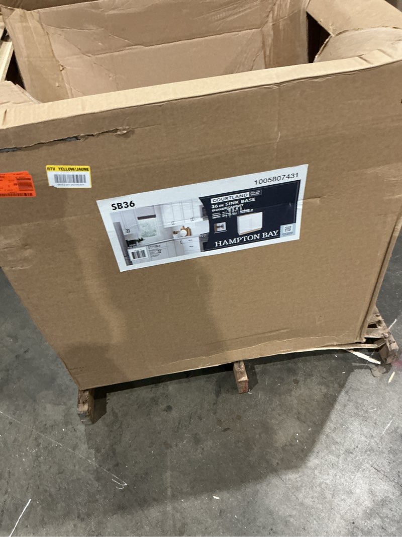 Condition photo showing As Is for hampton bay courtland 36 in. w x 24 in. d x 34.5 in. h assembled shaker sink base kitchen cabinet in polar white