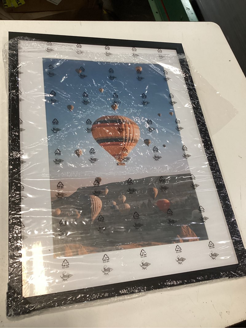 Condition photo showing As Is for wallsthatspeak 18x27 black picture frame for puzzles posters photos or artwork, set of 4