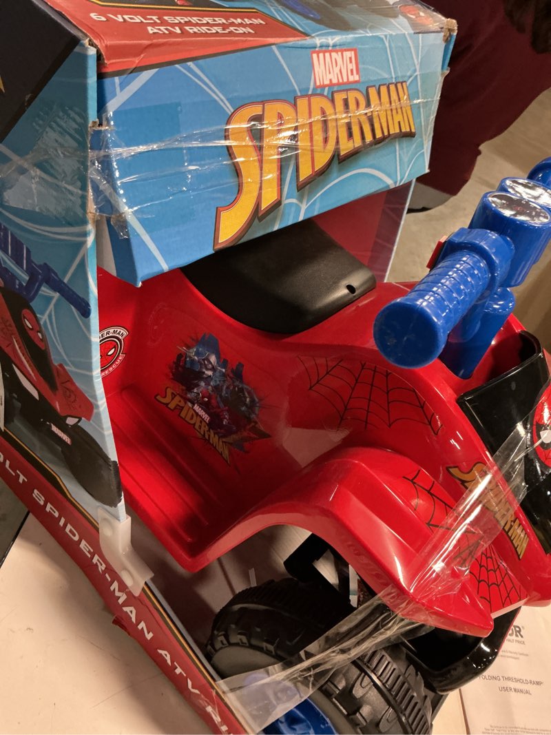 Condition photo showing As Is for spiderman atv, 6v battery powered ride on, ages 18m to 36m