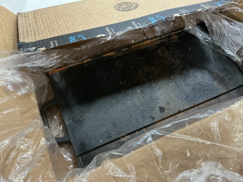 Condition photo showing As Is for prosource 2-in-1 reversible 19.5” x 9” cast iron griddle with handles, preseasoned & non-stick for gas stovetop, oven and open fire.