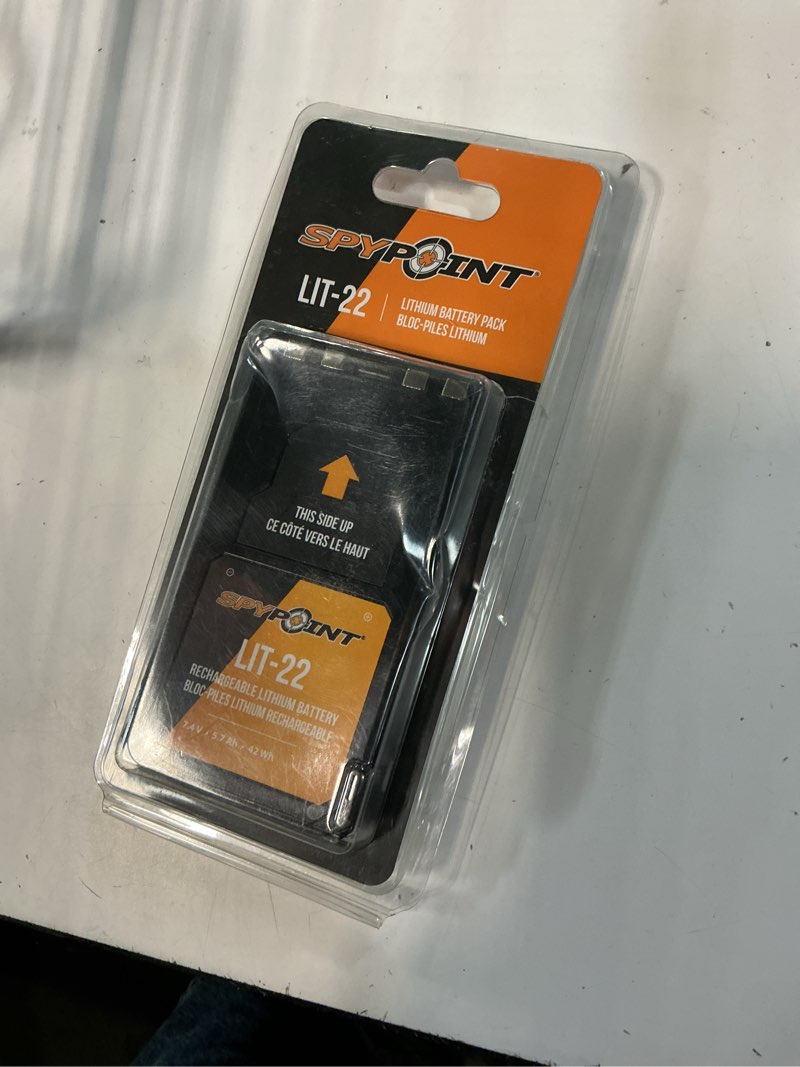Condition photo showing As Is for spypoint rechargeable 7.4v lithium battery pack for trail camera with 5.4 amp-hours and ac charging cable