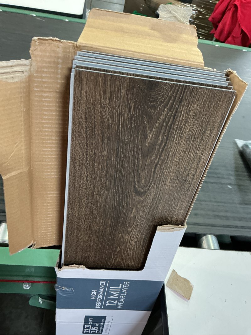Condition photo showing As Is for style selections tudor oak brown 12-mil x 7-in w x 48-in l waterproof interlocking luxury vinyl plank flooring (23.21-sq ft/ carton) 8 count