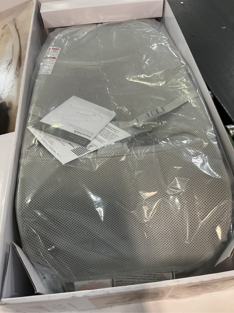 Condition photo showing New/Like New for munchkin spring baby bouncer and rocker seat, lightweight 2-in-1 design, travel essential for newborn, 3 recline positions, grey manual bouncer/rocker