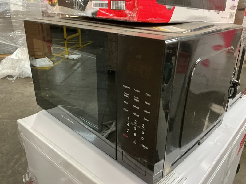 Condition photo showing As Is for Frigidaire 0.7 cu. ft. Countertop Microwave in Black