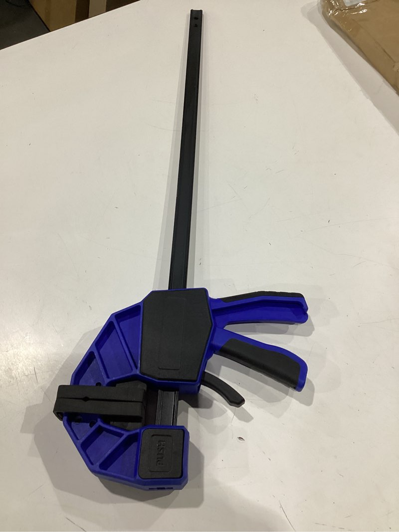 Condition photo showing New/Like New for trigger style quick grip clamp, heavy duty 24-inch bar clamp, 300 lbs clamping power, steel one-handed design, converts to spreader