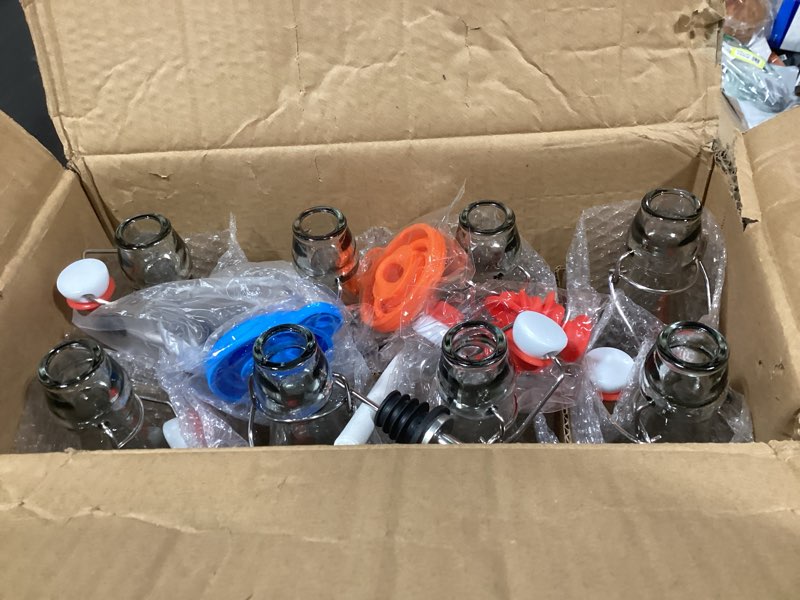 Condition photo showing New/Like New for 8 pack [1 l / 33 fl. oz.] swing top glass bottles w/ airtight stopper lids – flip top brewing bottle for fermentation, kombucha, mead, vinegar, beer, kefir, wine, soda – with 8 extra seals & 2 pourer