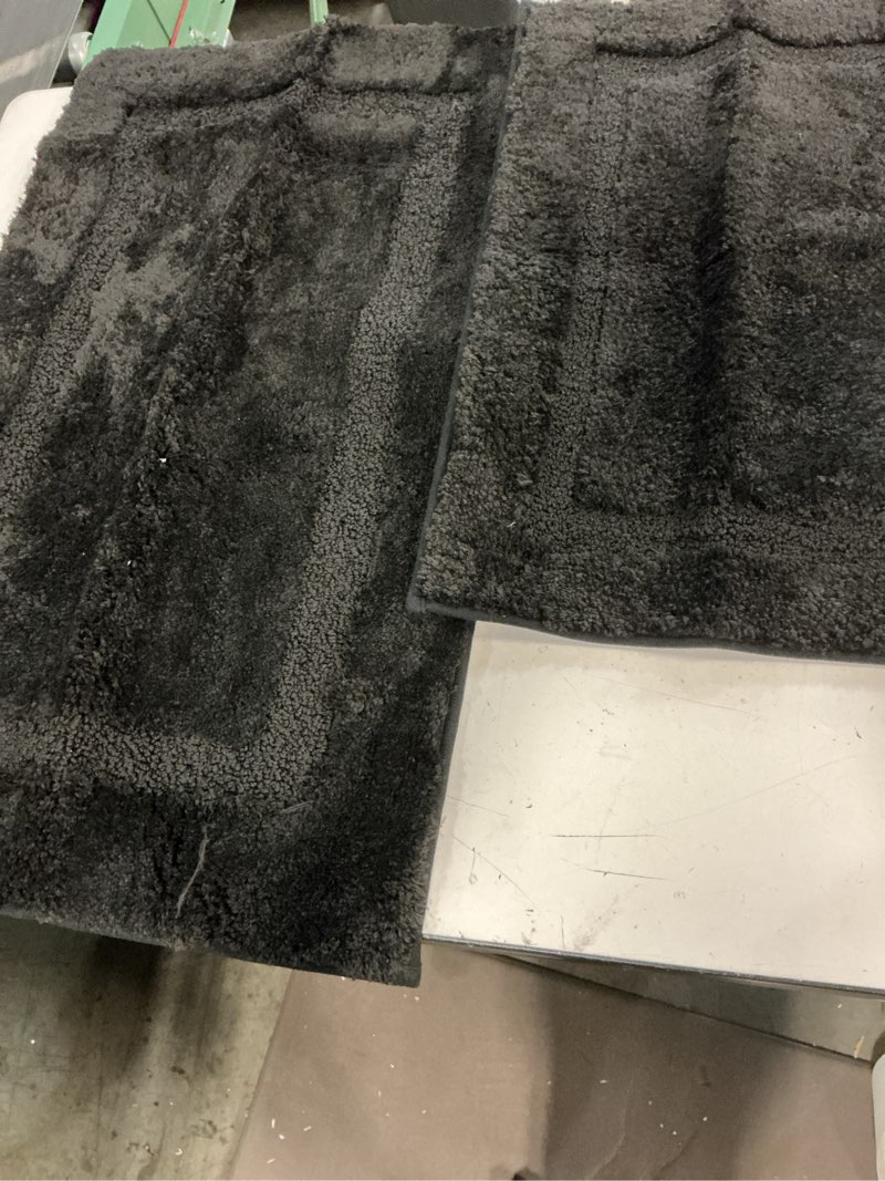 Condition photo showing As Is for black alfonbra for 2-piece bathroom top: 100% microfiber back: thermo-plastic-rubber