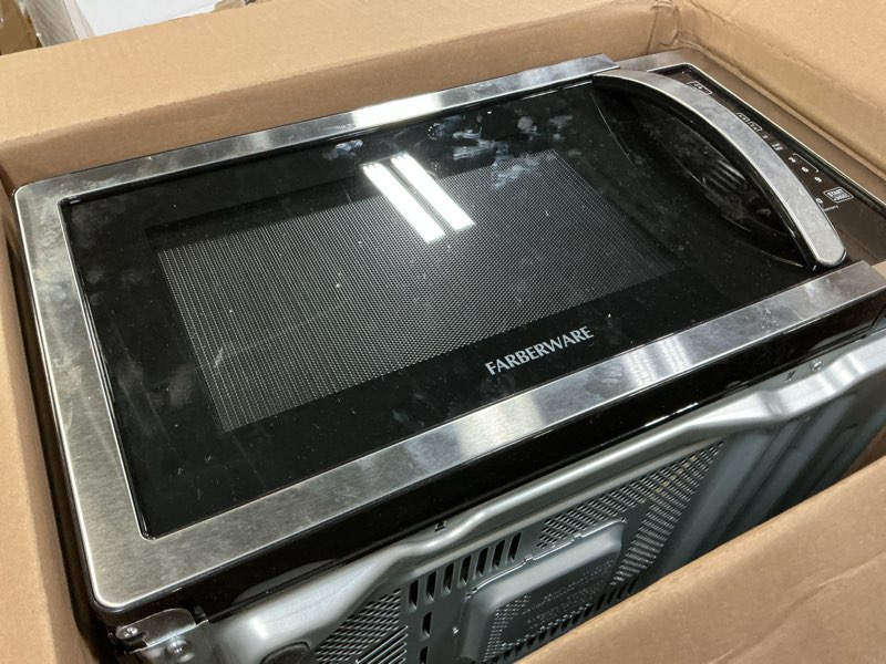 Condition photo showing As Is for Farberware 0.7 Cu. Ft. Countertop Microwave Oven – 700 Watts Power, Auto Cook Settings, Defrost, Easy Clean and Child Safety Lock - Stainless 0.7 Cu. Ft Stainless Steel