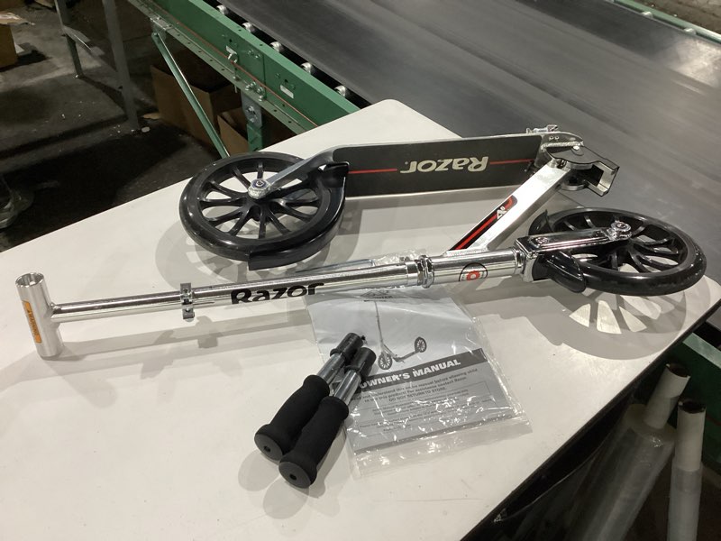 Condition photo showing As Is for razor a6 kick scooter for kids ages 8+ - extra-tall handlebars & longer deck, 10" urethane wheels, anti-rattle technology, for riders up to 220 lbs silver