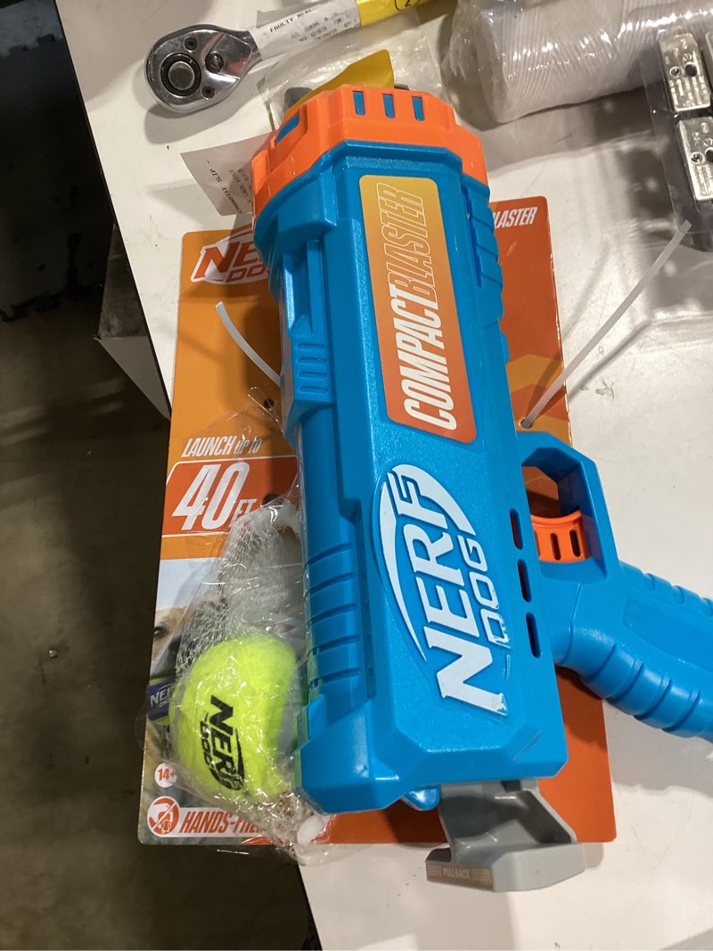 Condition photo showing As Is for nerf 4.1" blaster with 2.5" non-squeak 2pk tennis ball dog toy